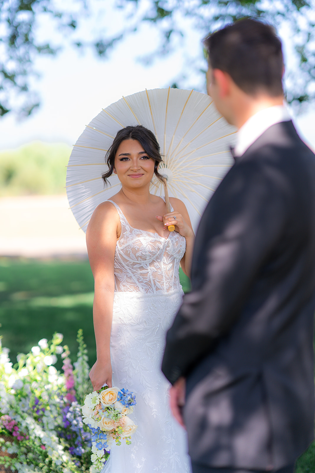 Bride and groom posing together outdoors in a garden at Rainbow Oaks Ranch in Sanger, California.