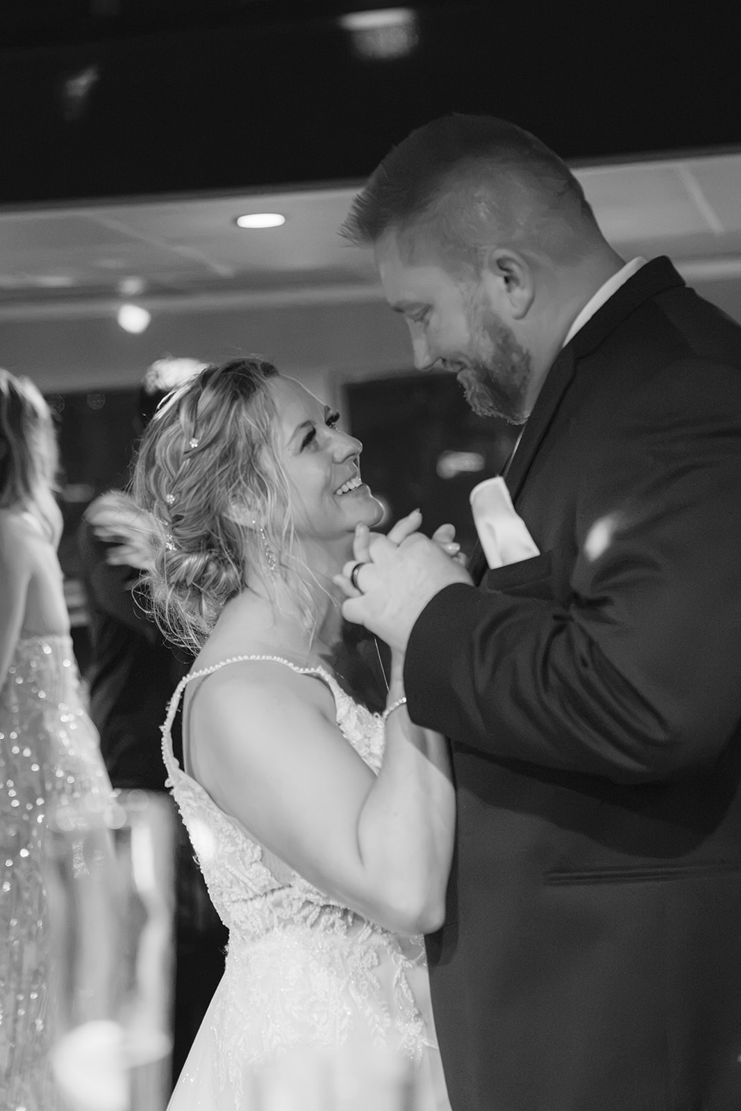 Black and white photo of a bride and groom dancing together during a boat wedding reception in San Francisco