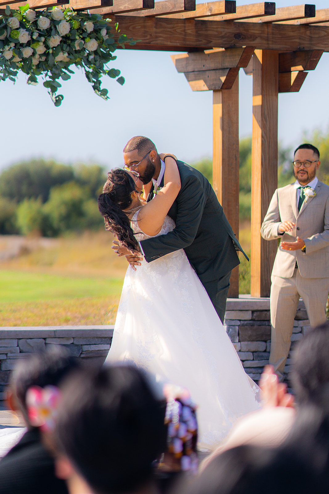 Bride and groom sharing a romantic dip kiss at Fairview Metropolitan in Oakland, California.