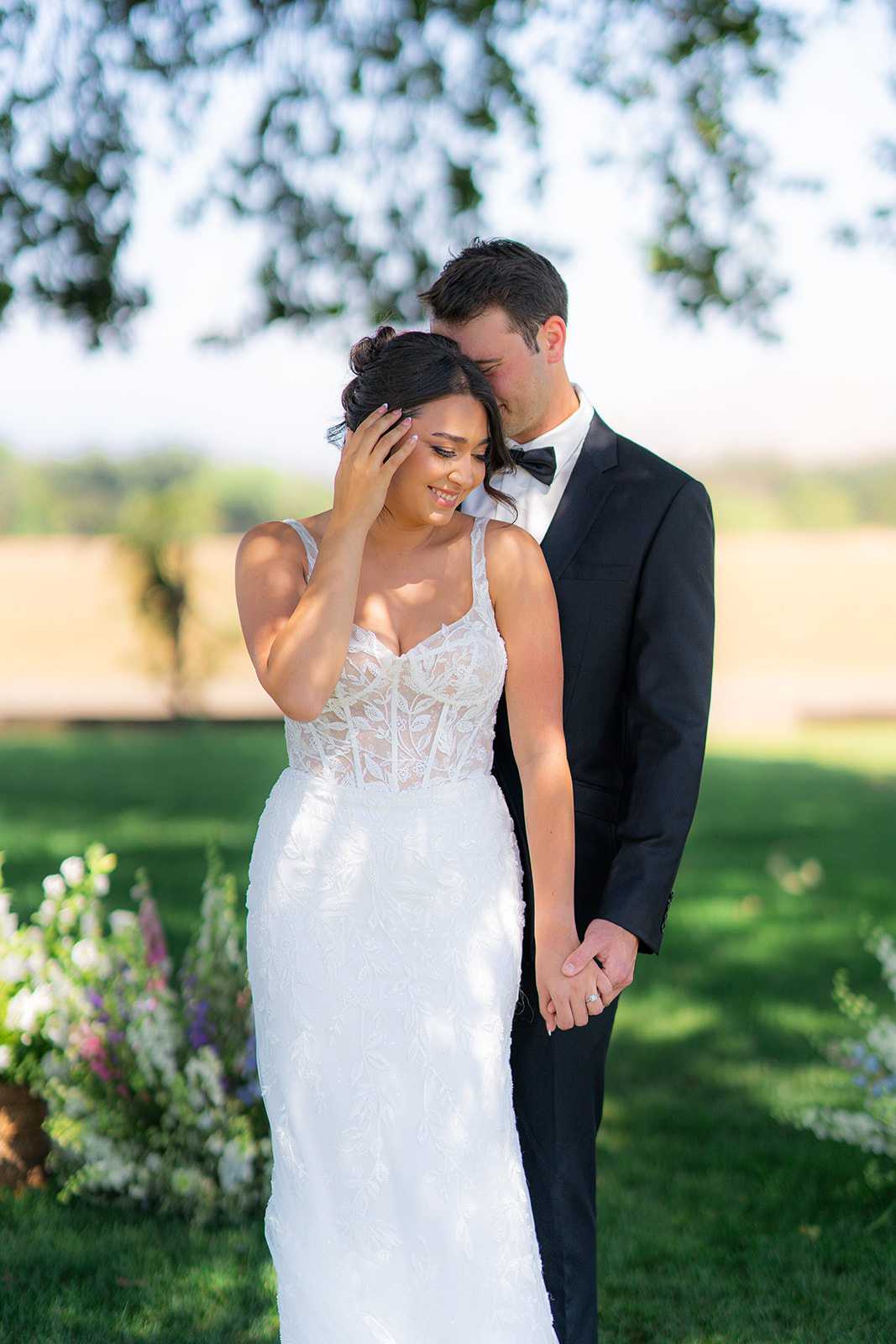 Bride and groom posing together for a wedding portrait at Rainbow Oaks Ranch in Sanger, California.