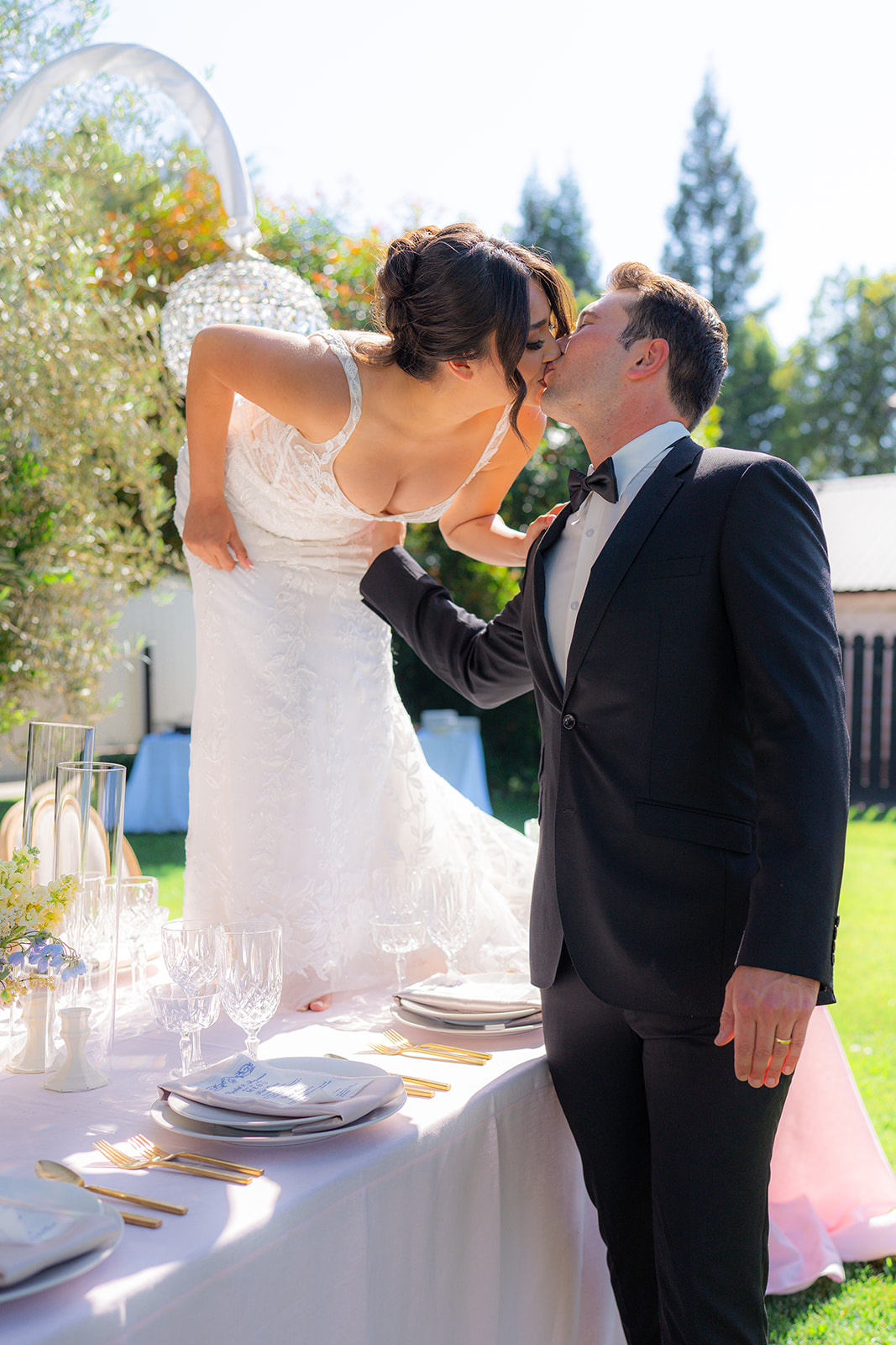 Bride and groom standing together on a table for an editorial wedding portrait at Rainbow Oaks Ranch in Sanger, California.