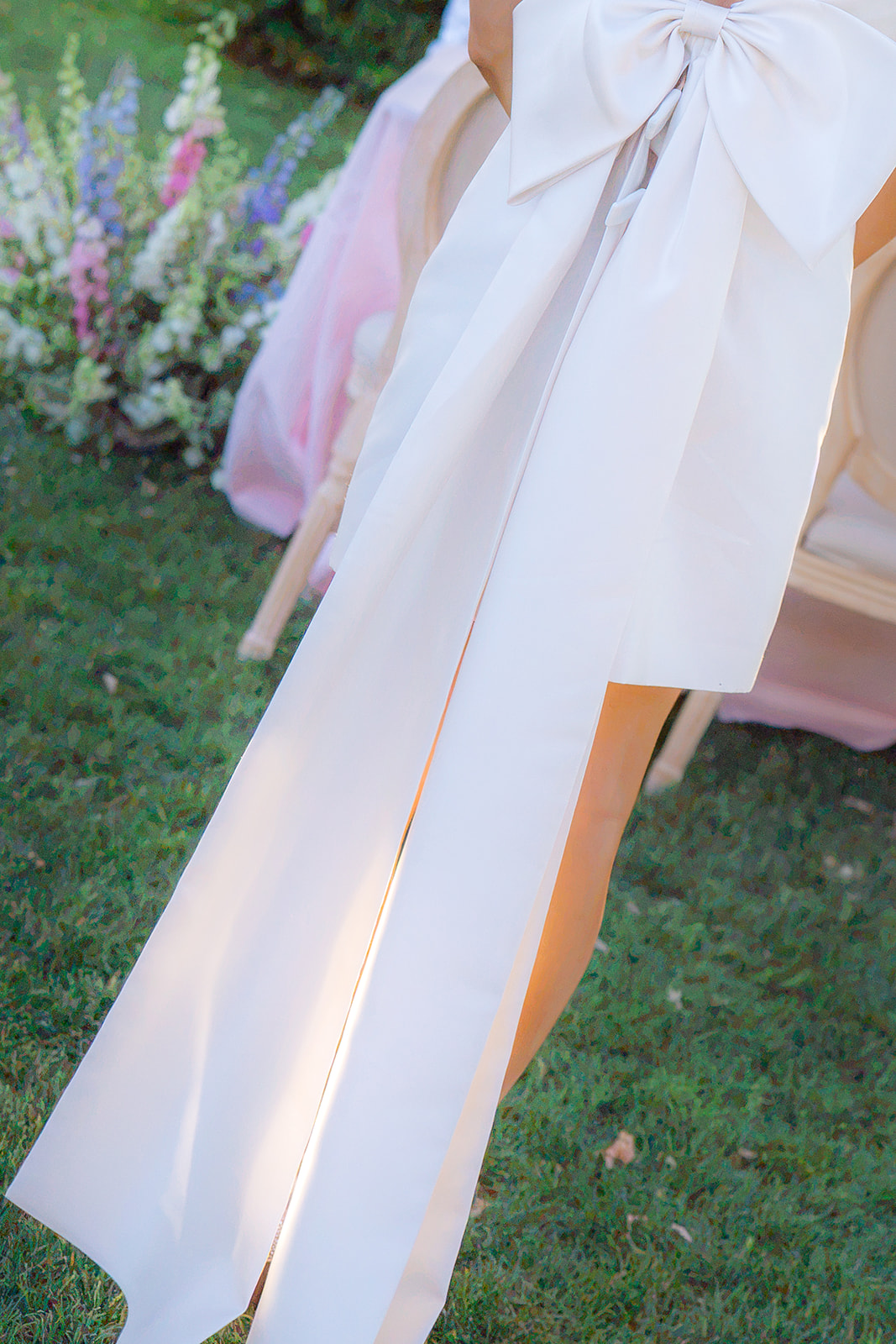 Bride wearing a reception dress with a statement bow at Rainbow Oaks Ranch in Sanger, California.