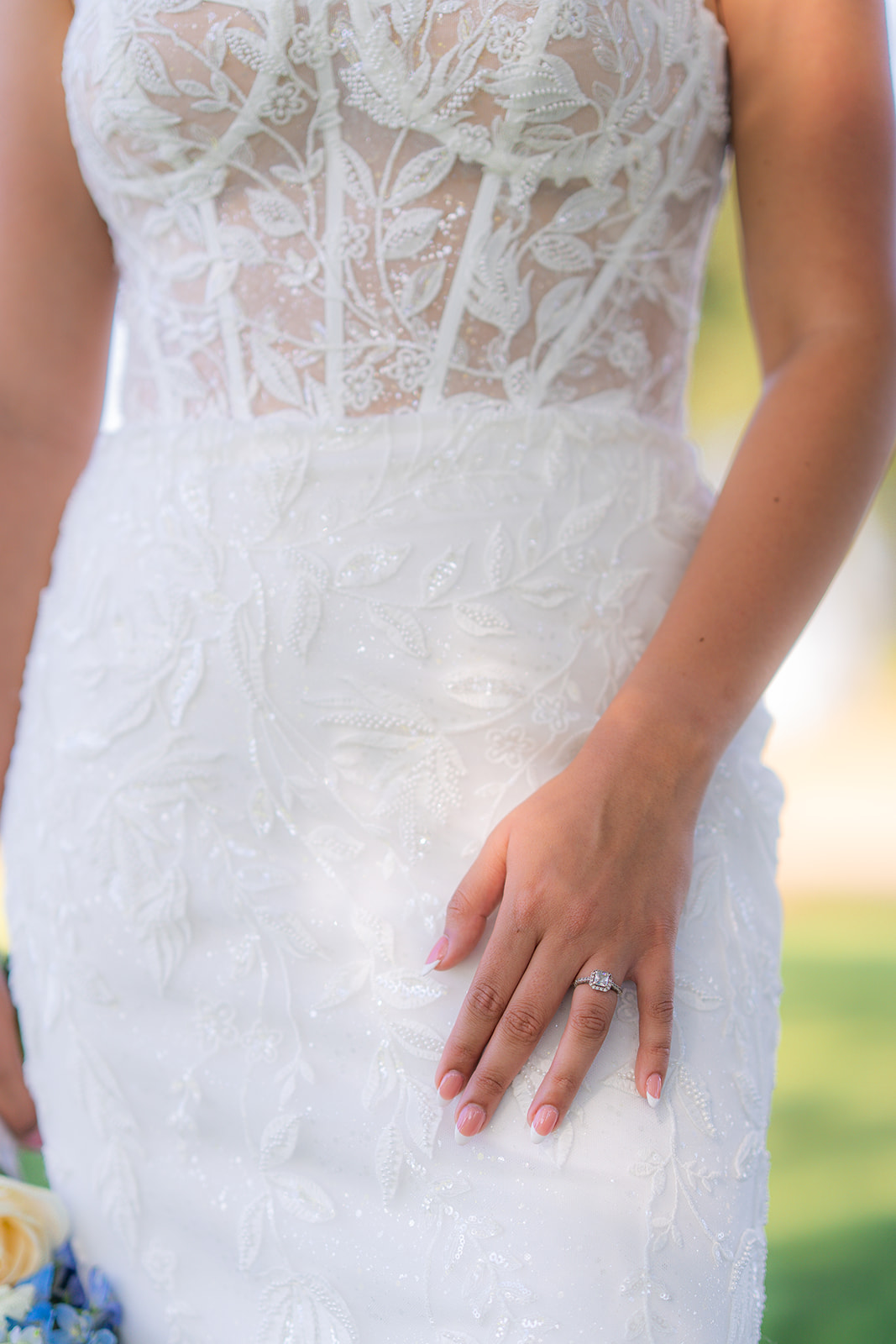 Close-up photograph of a bride’s wedding dress and ring at Rainbow Oaks Ranch in Sanger, California.
