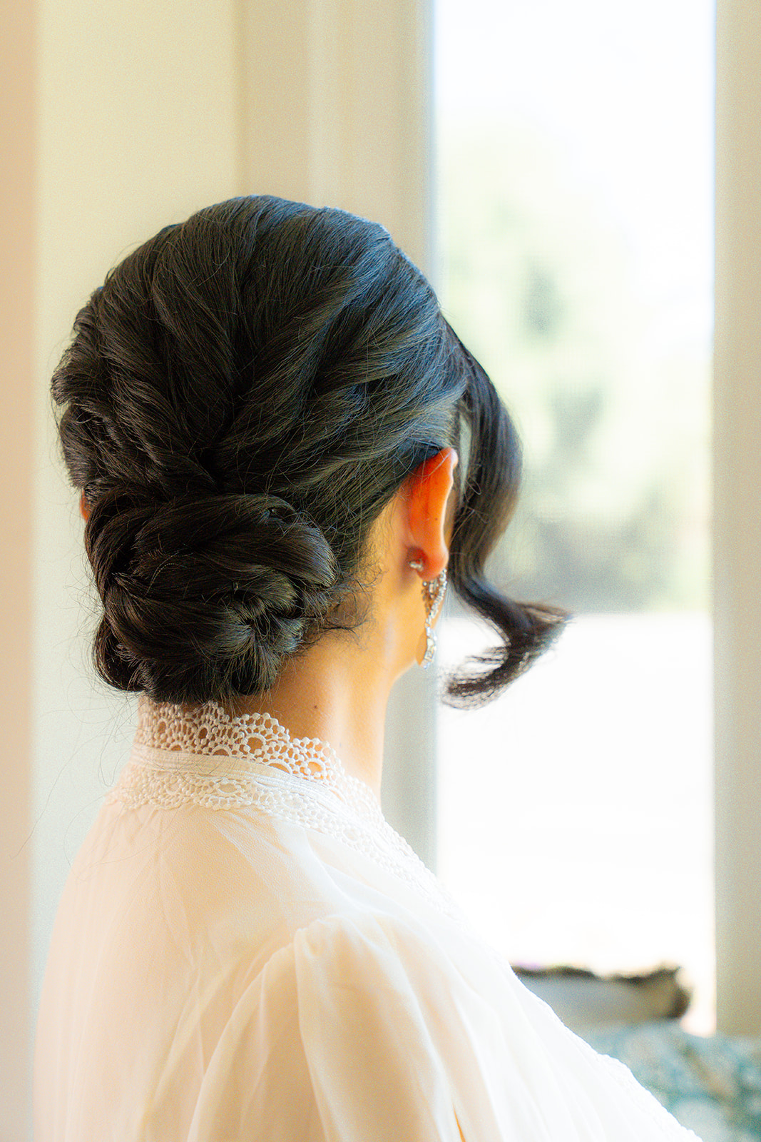 Bridal portrait highlighting the bride’s hair styled in a bun at Olive Hill Estate in Byron, California.