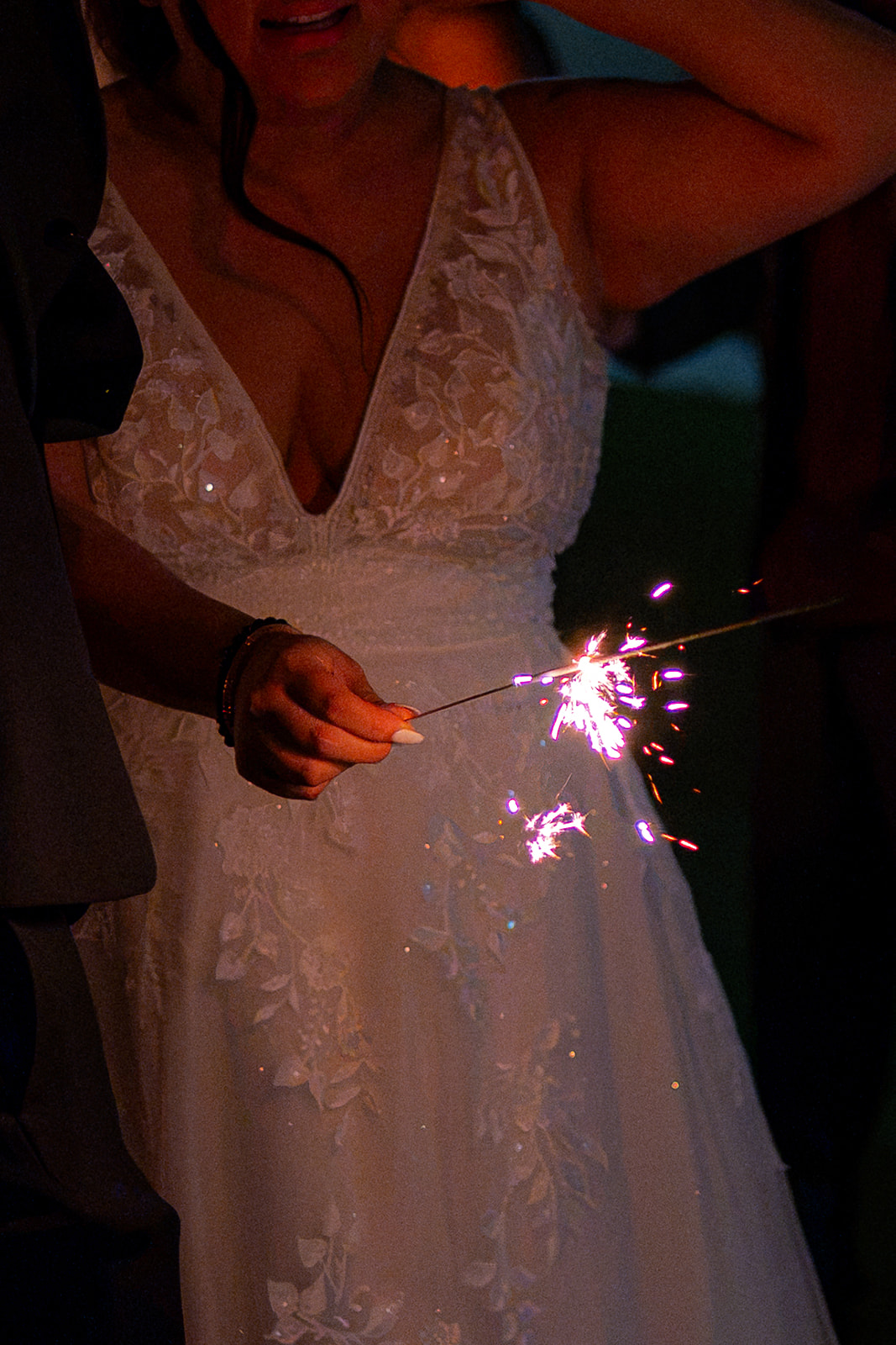 Bride holding a lit sparkler during her wedding celebration at Fairview Metropolitan in Oakland, California.