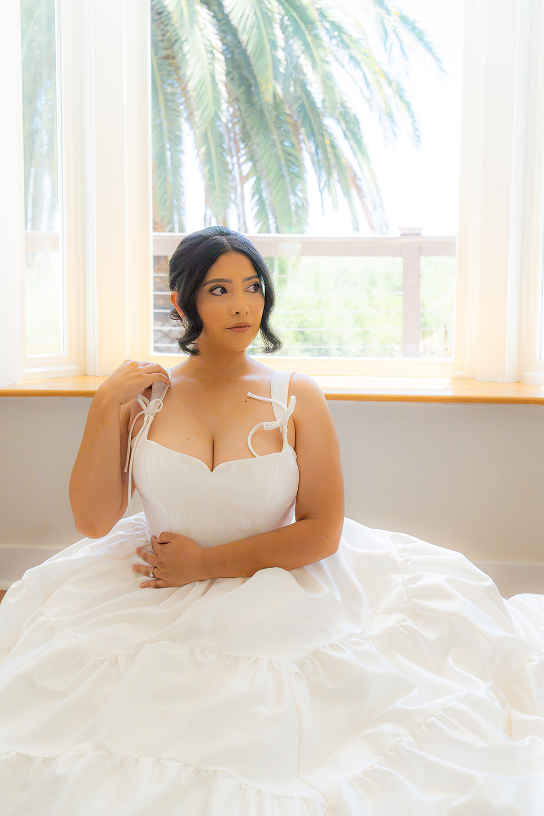 Bride sitting in the bridal suite at Olive Hill Estate in Byron, California.