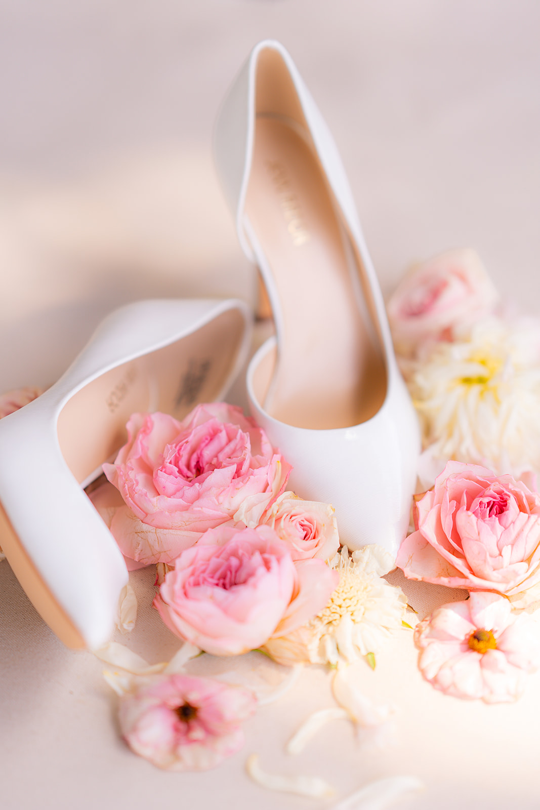 Flat lay photograph of bridal shoes arranged with flowers at Rainbow Oaks Ranch in Sanger, California.