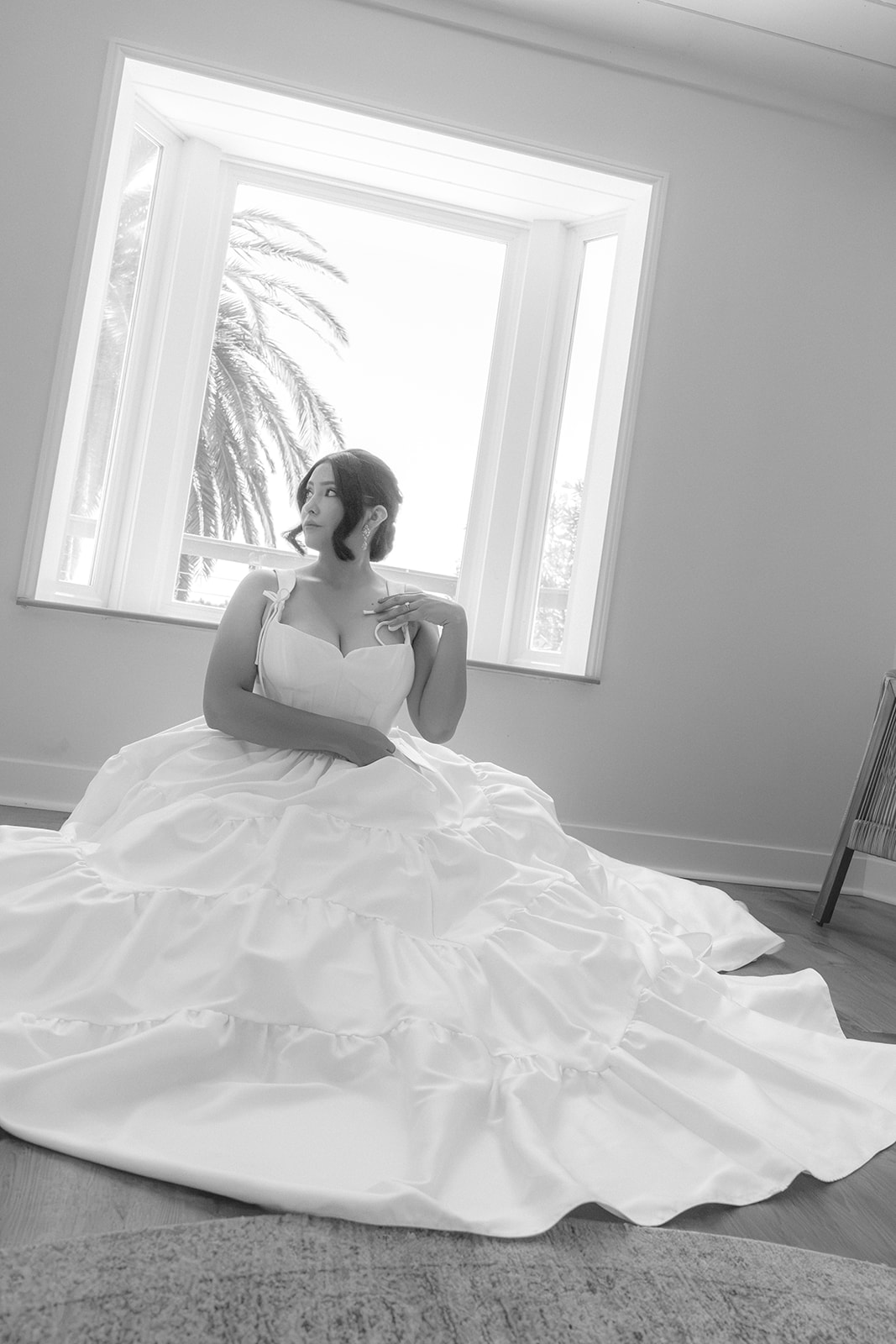 Bride sitting on the floor for a bridal portrait at Olive Hill Estate in Byron, California.