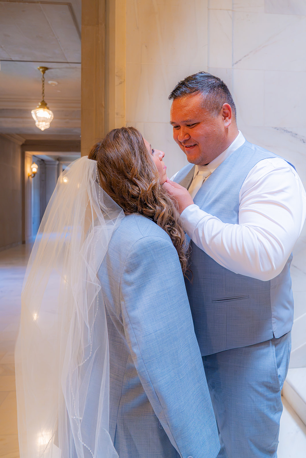Bride wearing the groom’s jacket during a wedding at San Francisco City Hall.