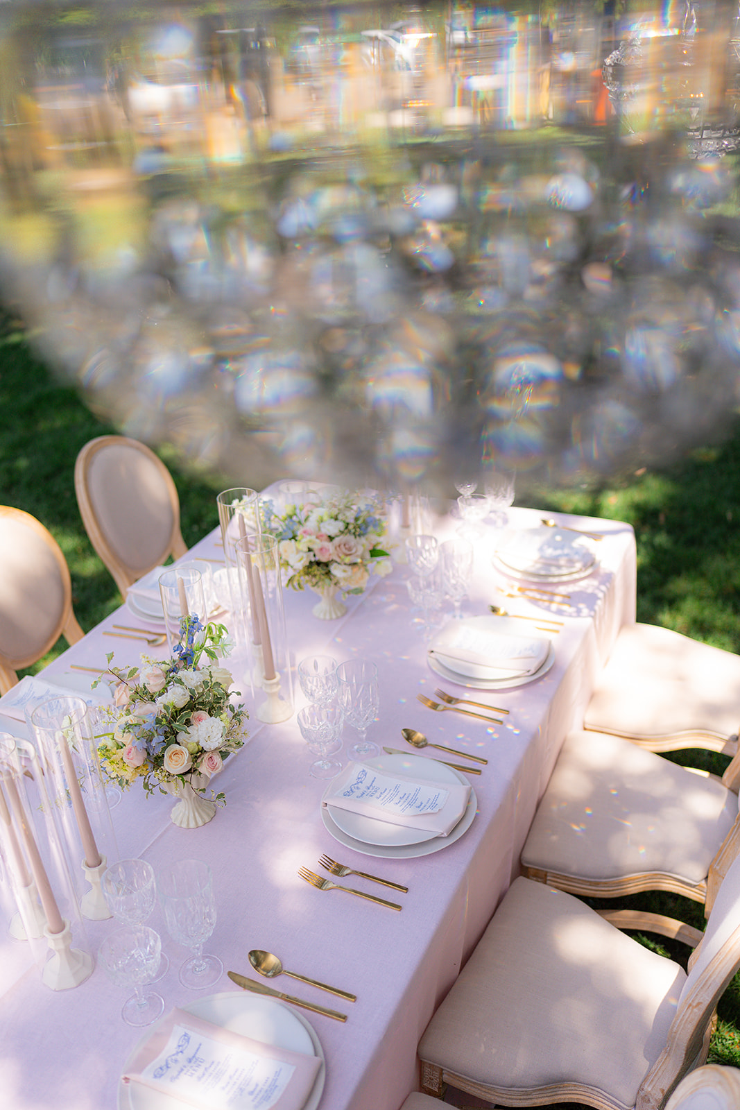 Garden wedding reception tablescape with a chandelier at Rainbow Oaks Ranch in Sanger, California.