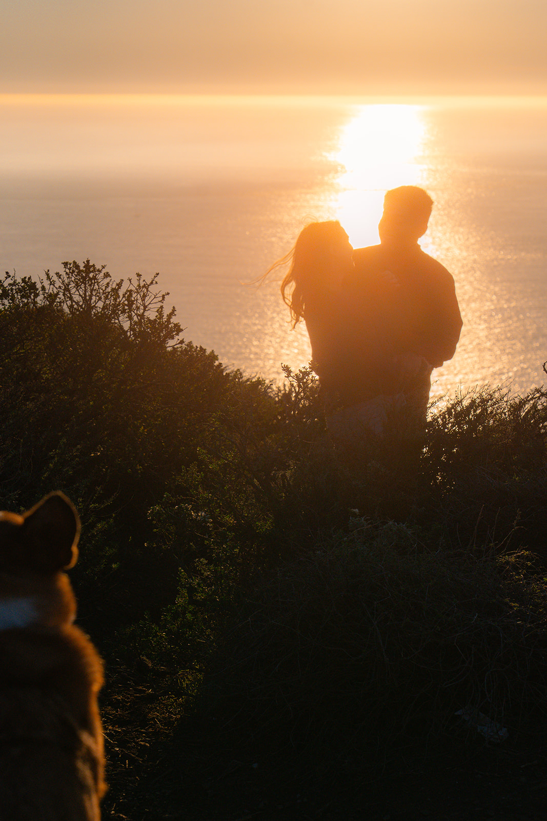 Couple dancing at sunset with sparkling ocean views near San Francisco.