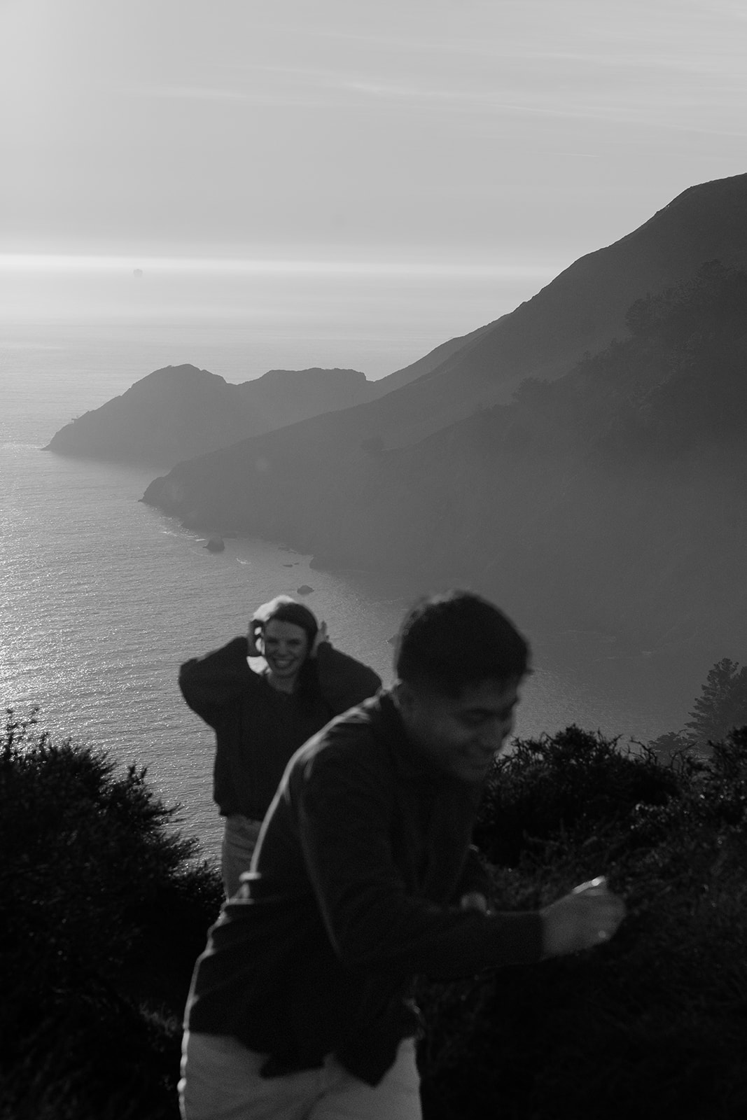 Couple standing on a scenic cliffside during sunset near San Francisco.