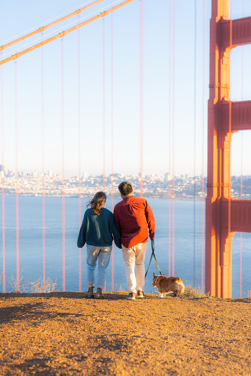 Couple standing together with the Golden Gate Bridge in the background.