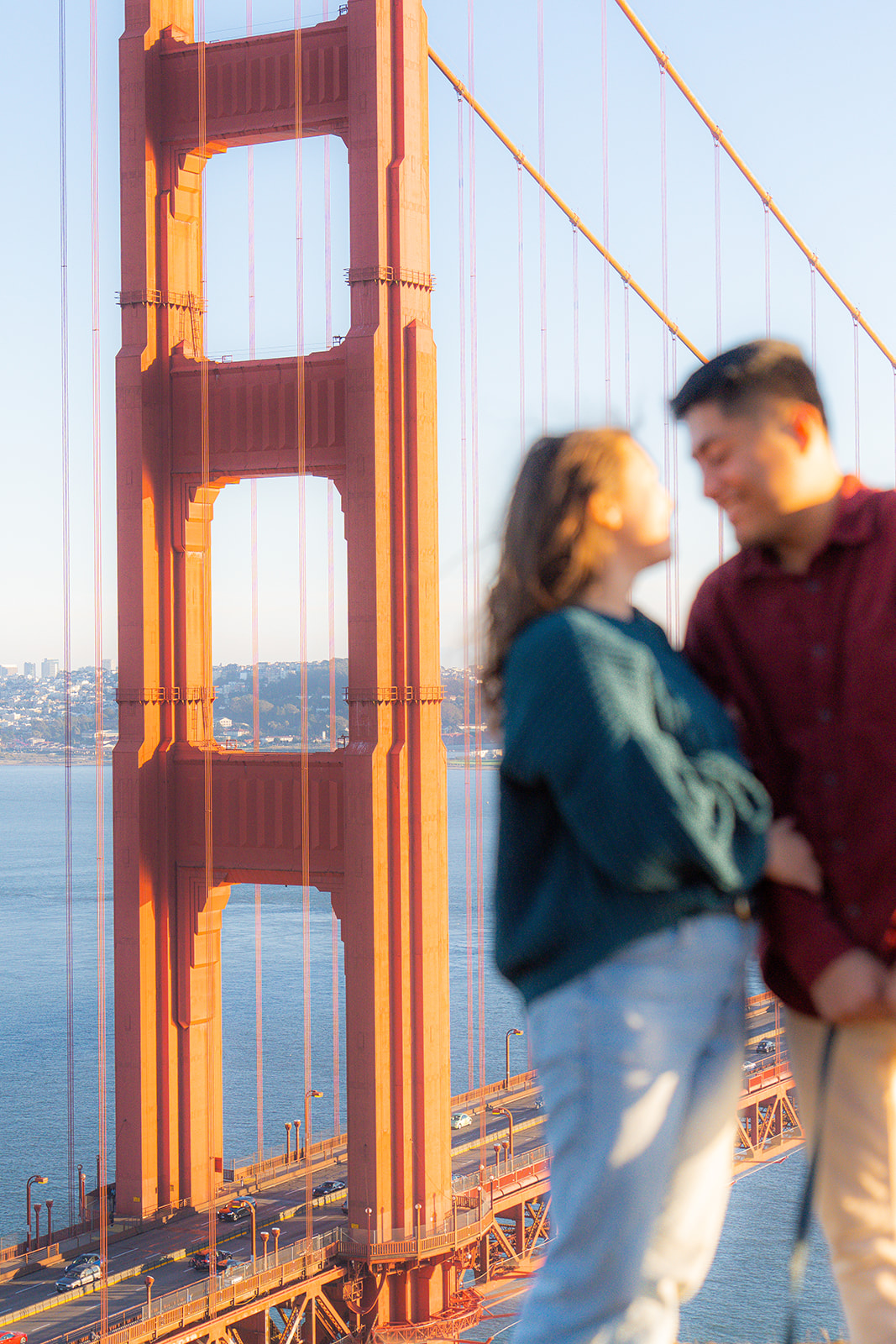 Couple standing together in front of the Golden Gate Bridge near San Francisco.