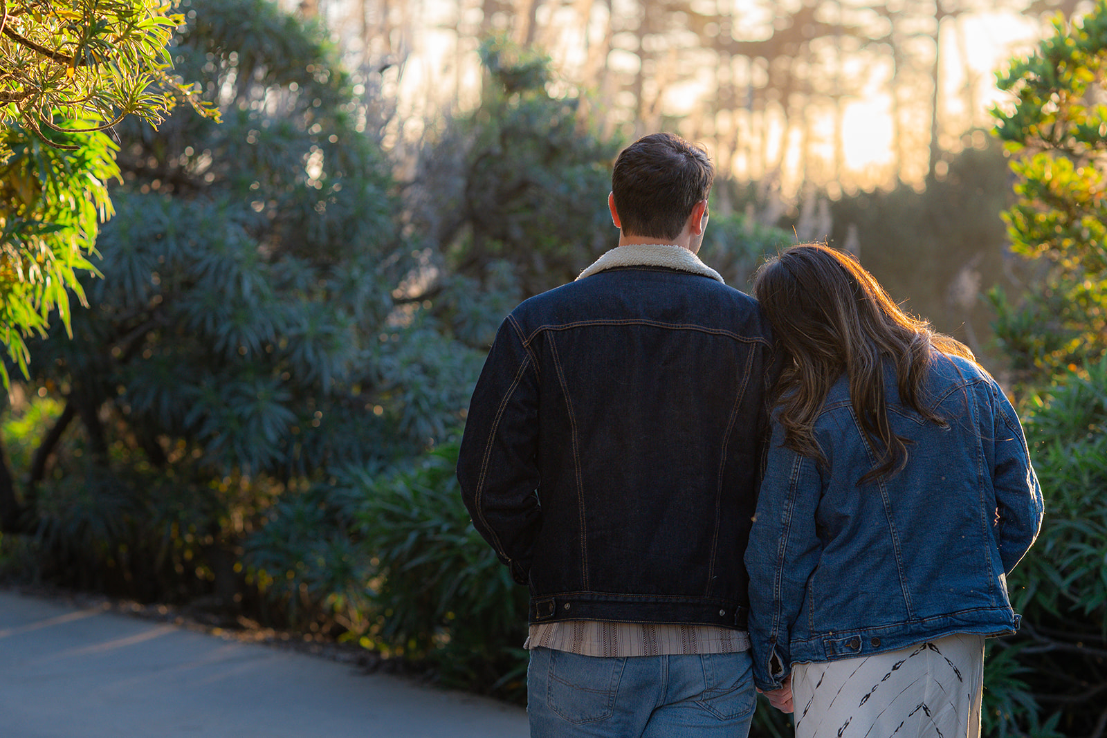 Couple walking along a scenic pathway at Seascape Beach Resort in Aptos, California.
