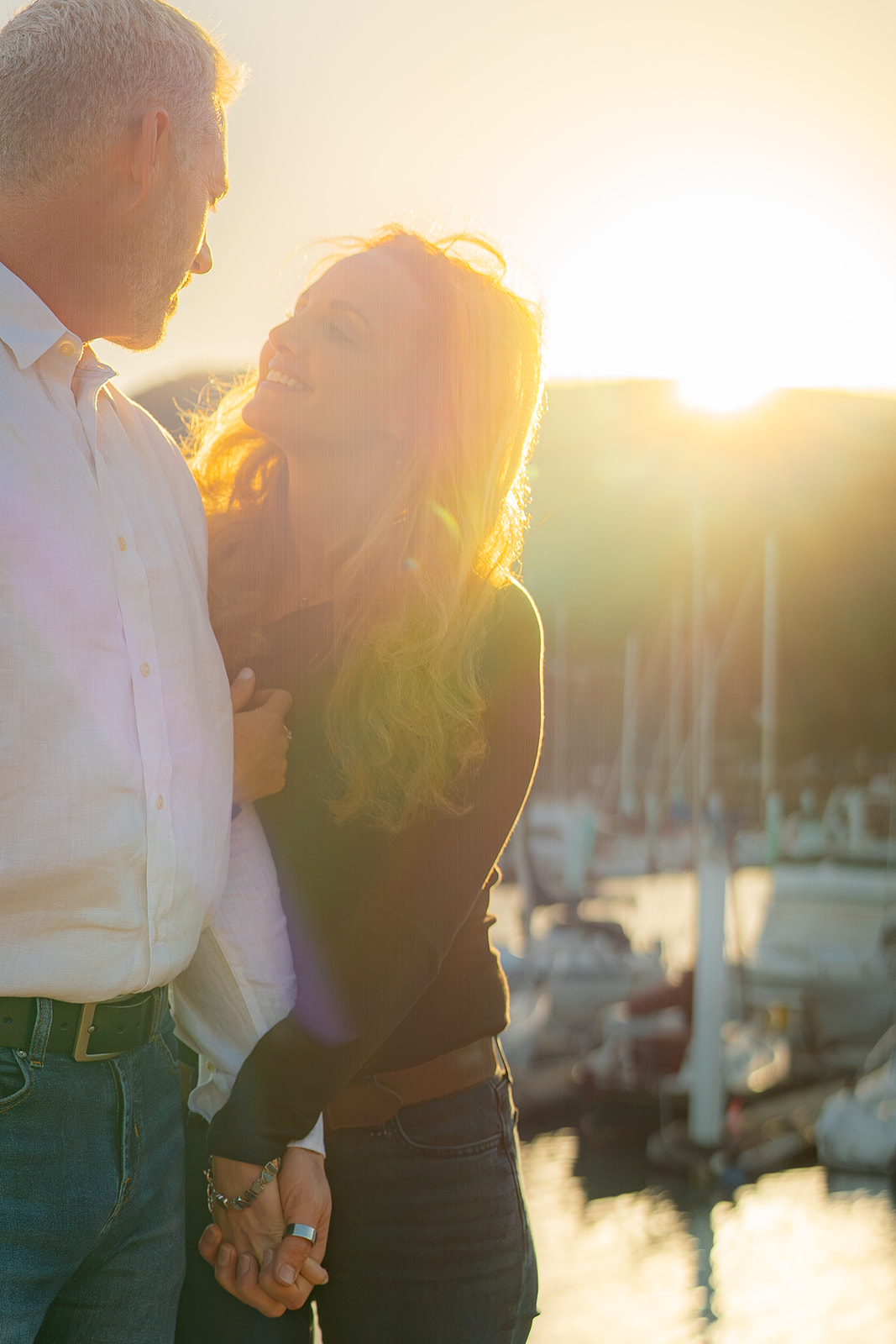 Couple in dreamy sunset light by the marina at Cavallo Point near the Golden Gate Bridge