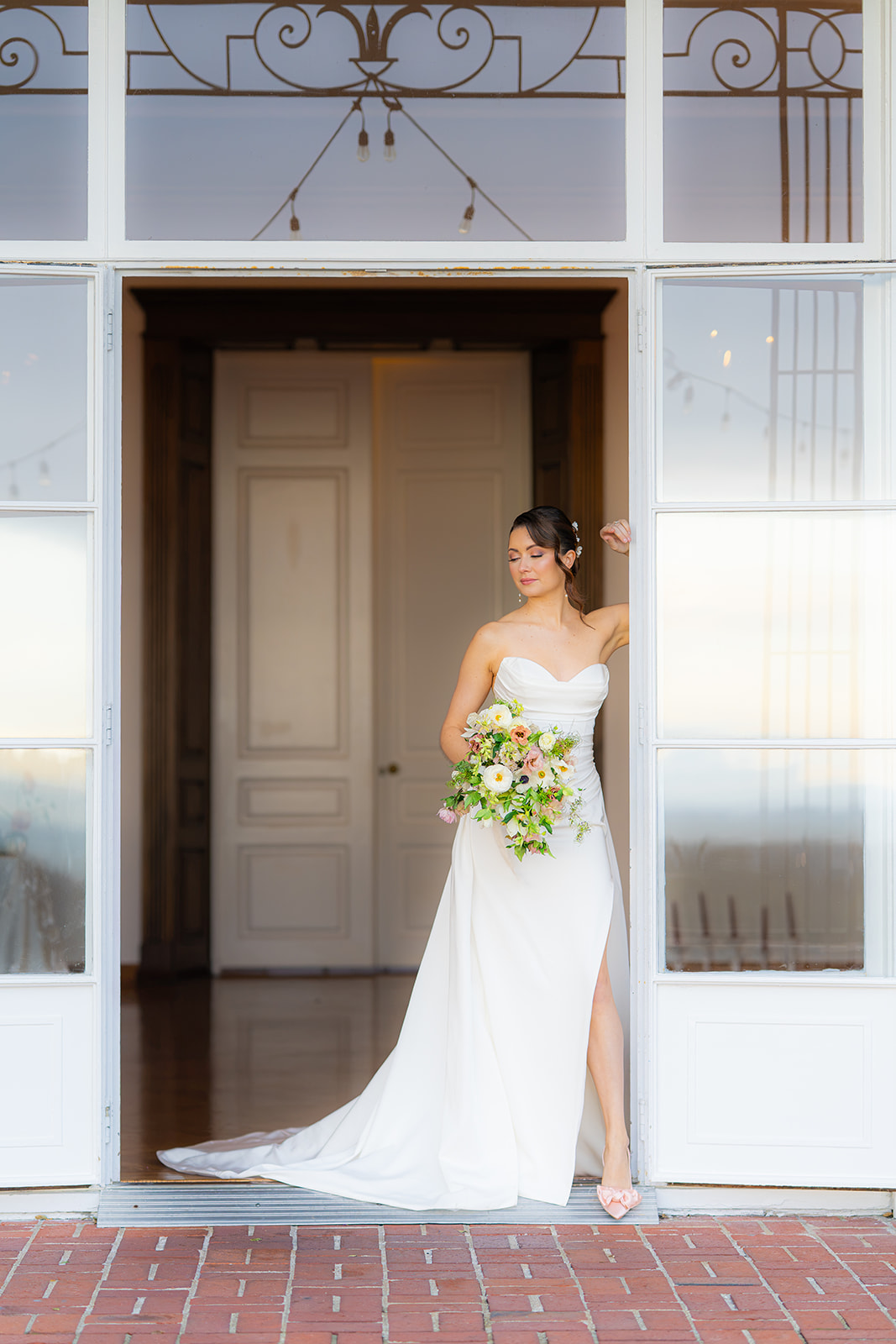 Bride posing by double doors at Hollins House in Santa Cruz, California.