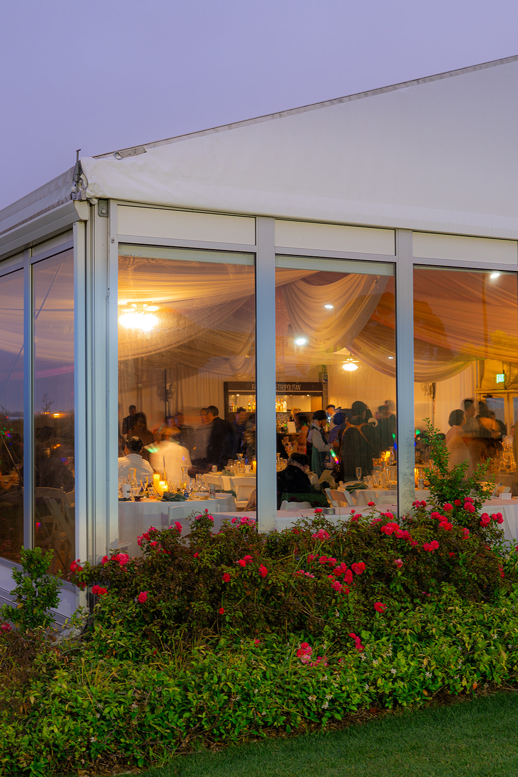 Wedding reception inside a tent at Fairview Metropolitan in Oakland, California, photographed with motion blur.