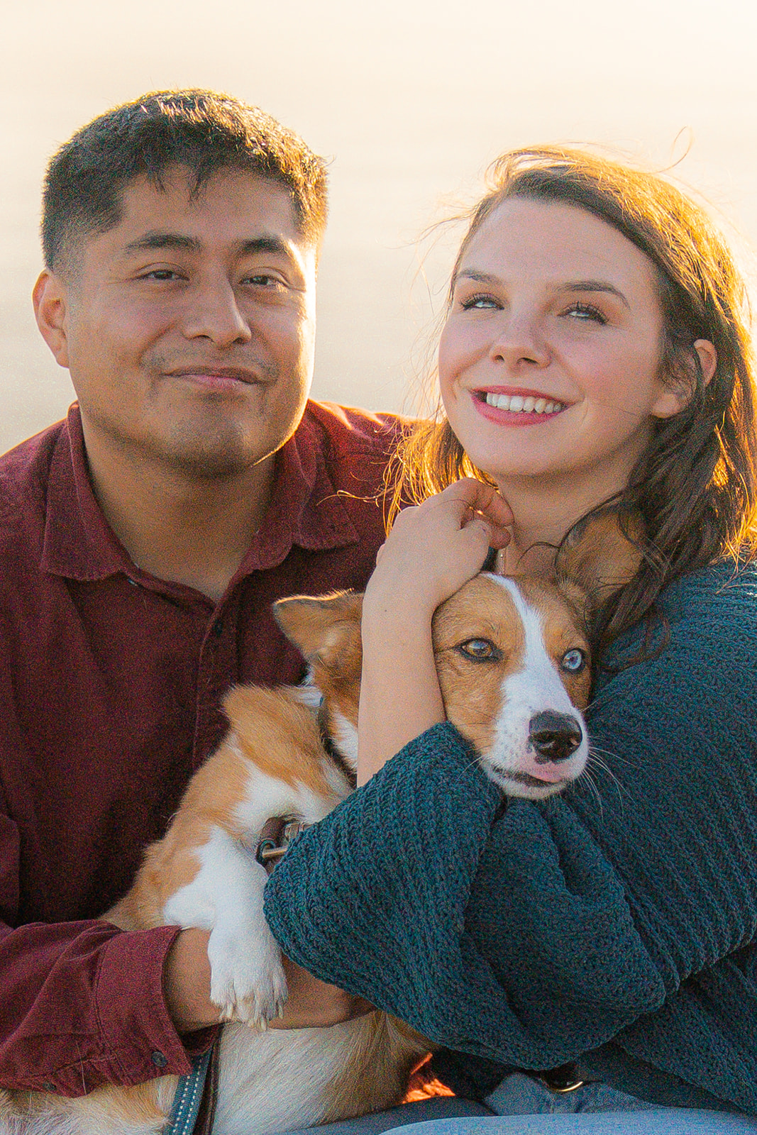 Couple having fun with their corgi at sunset in San Francisco.