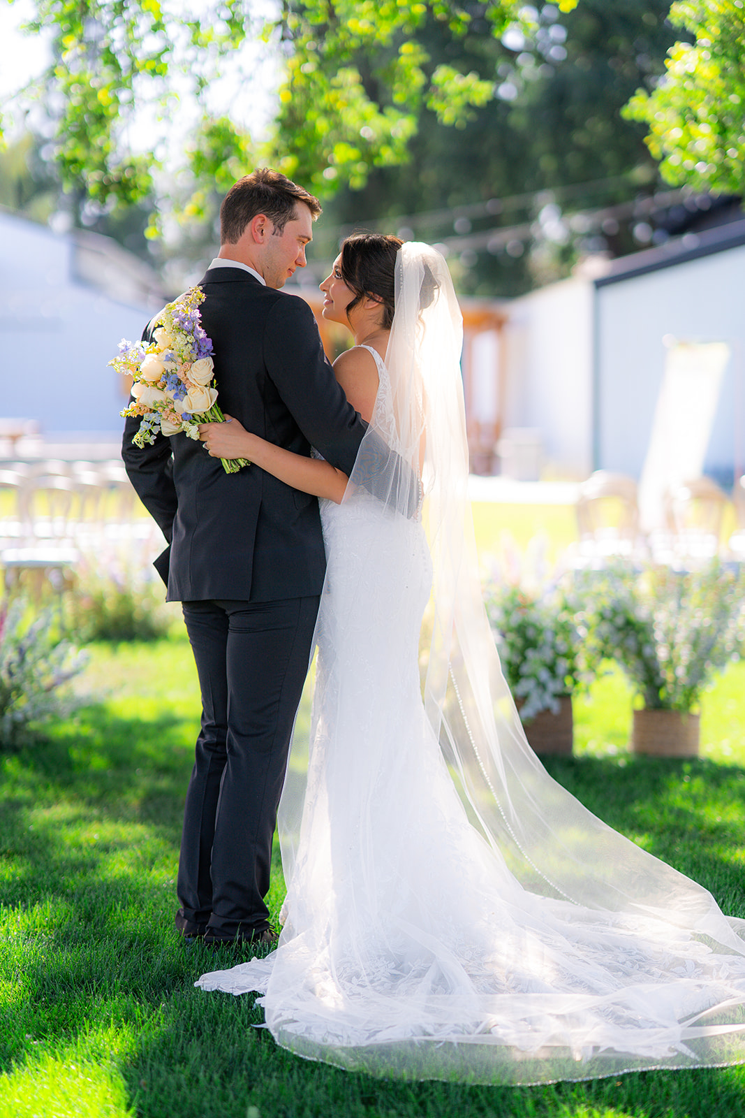 Bride and groom during their outdoor garden wedding ceremony at Rainbow Oaks Ranch in Sanger, California.