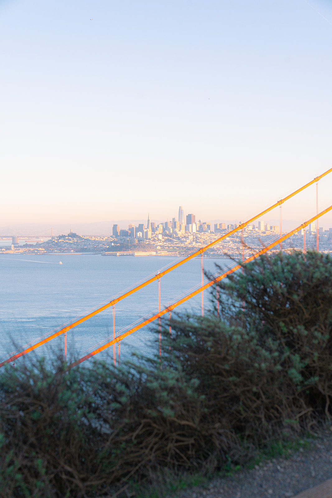 Golden Gate Bridge with the San Francisco skyline and ocean views in the distance.