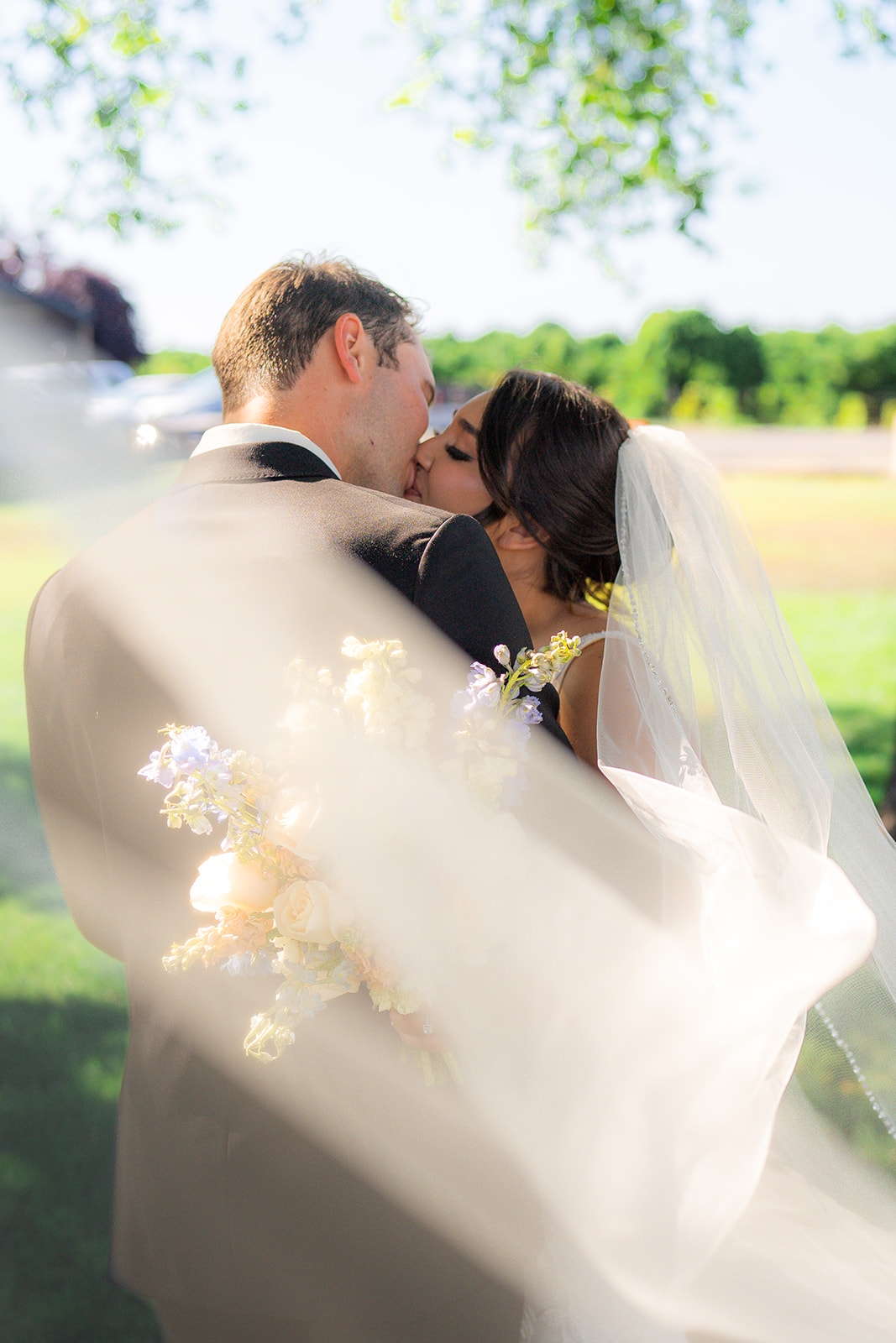Bride and groom posing for an outdoor garden wedding portrait at Rainbow Oaks Ranch in Sanger, California.