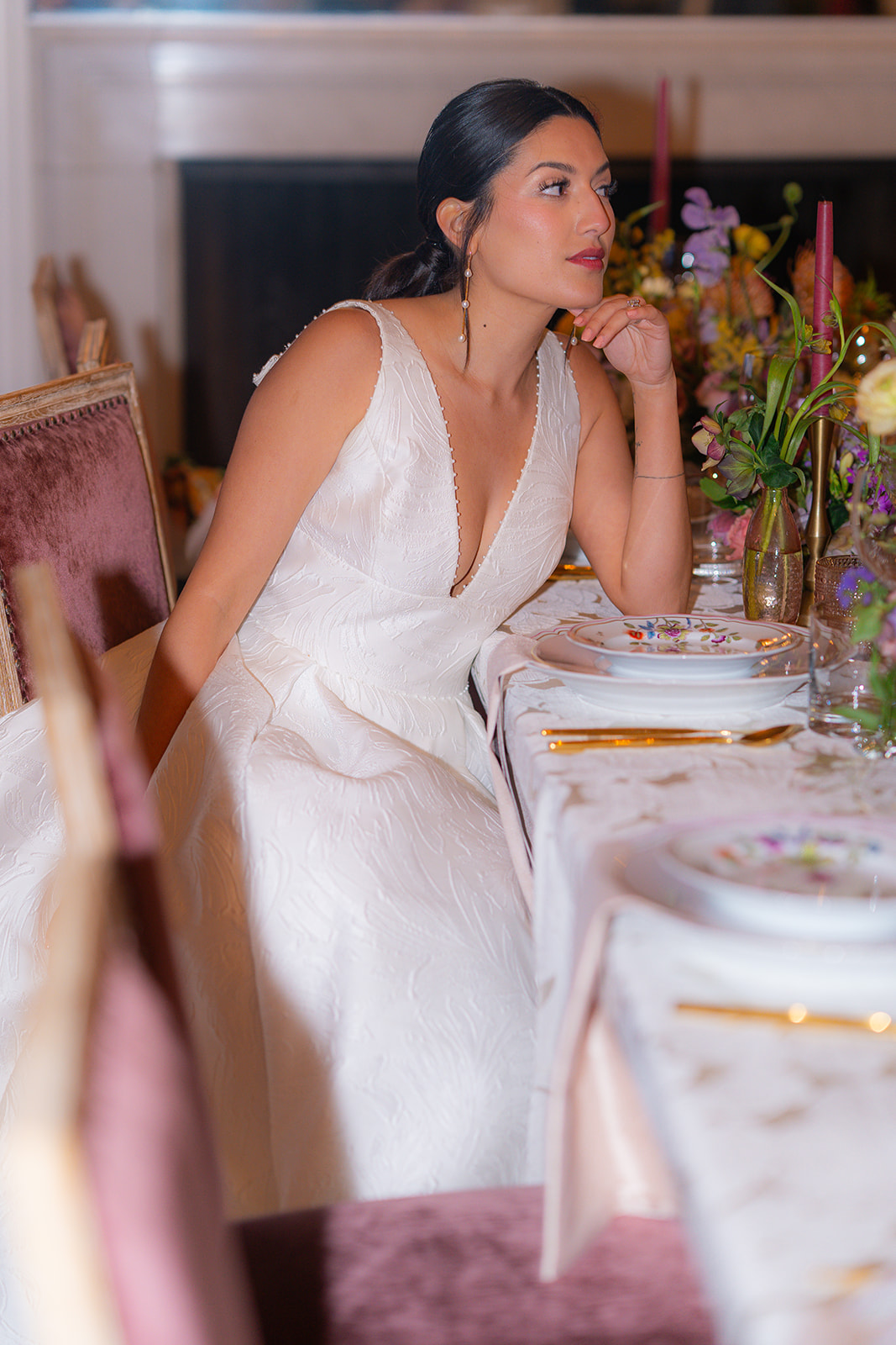 Bride sitting at a table during her wedding reception at Hollins House in Santa Cruz, California.