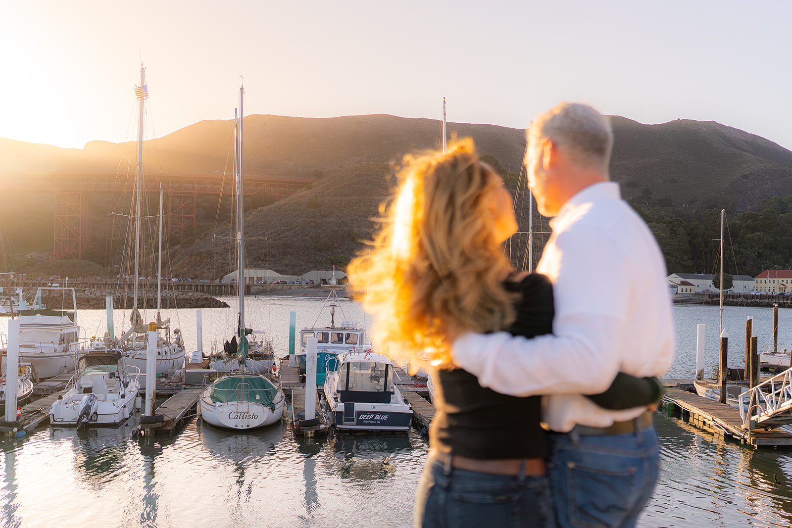 Couple at sunset overlooking the marina and San Francisco Bay at Cavallo Point near the Golden Gate Bridge