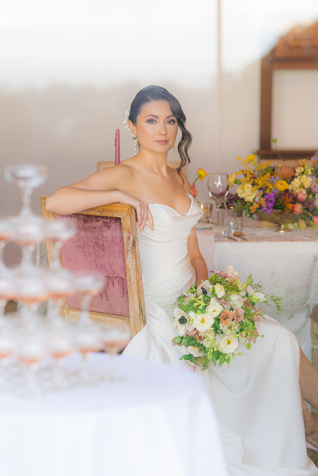 Bride photographed through a window with a champagne tower at Hollins House in Santa Cruz, California.