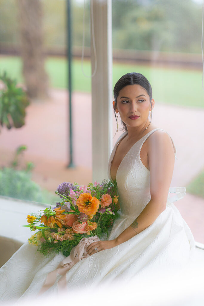 Bride sitting in a window at Hollins House in Santa Cruz, California.