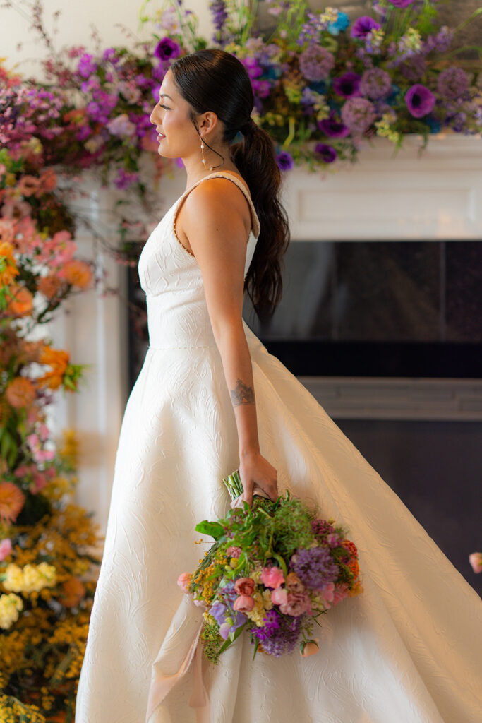 Bride walking with her wedding bouquet at Hollins House in Santa Cruz, California.