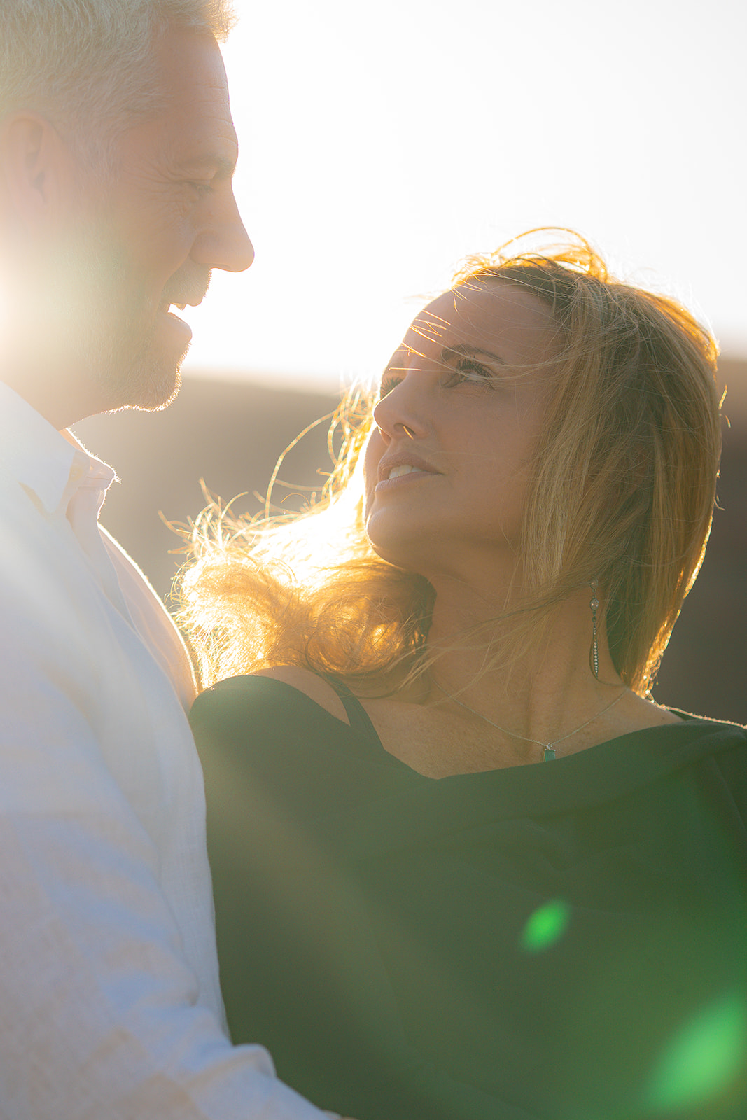 Romantic couple glowing in sunset light at Cavallo Point with the Golden Gate Bridge in the background
