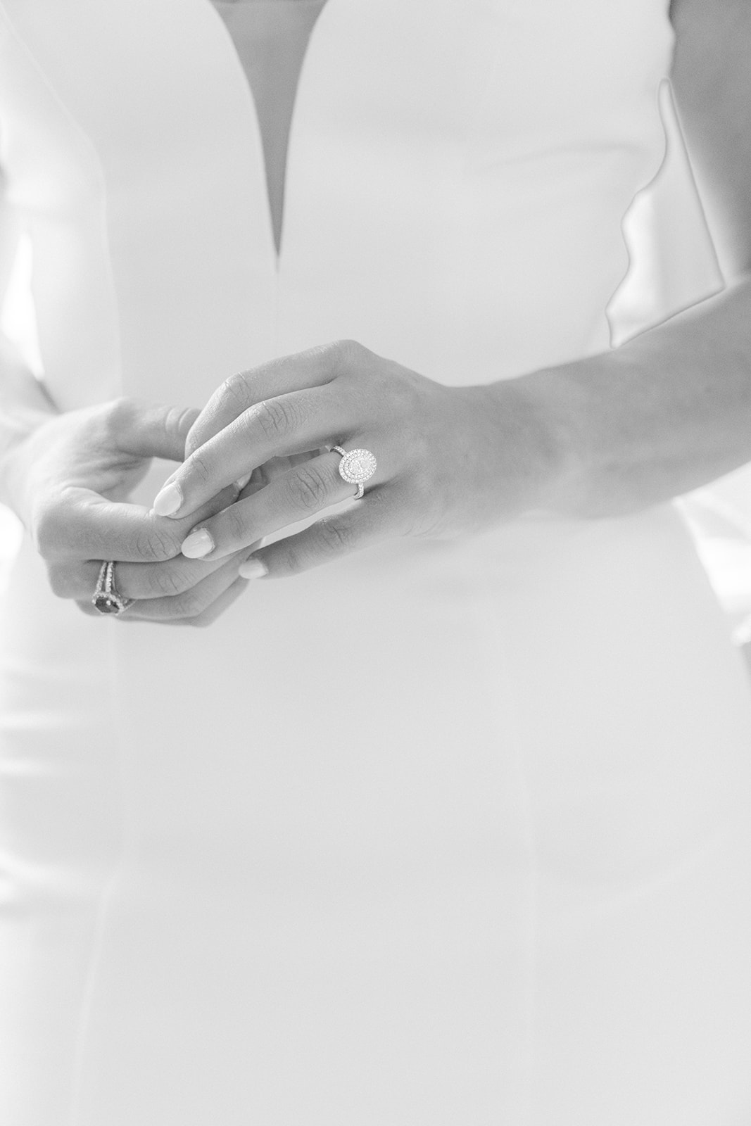 Black-and-white bridal photograph highlighting the bride’s wedding ring and dress in San Francisco, California.