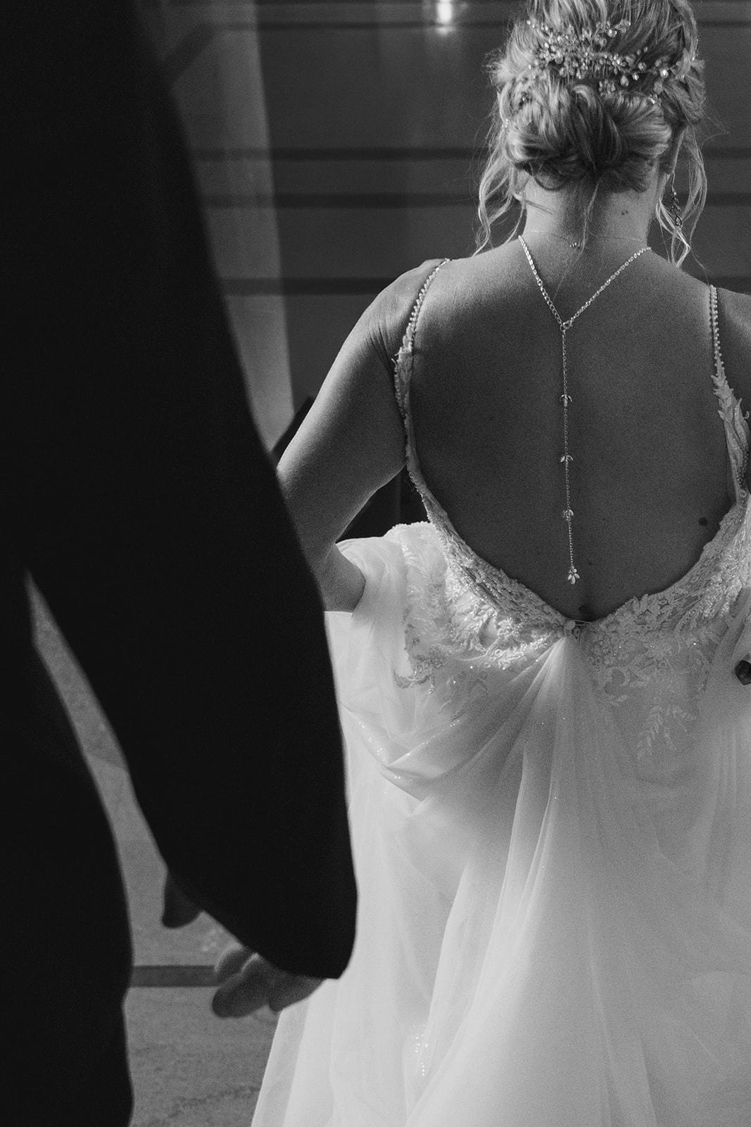 Bride and groom walking together through the halls of San Francisco City Hall after their wedding ceremony