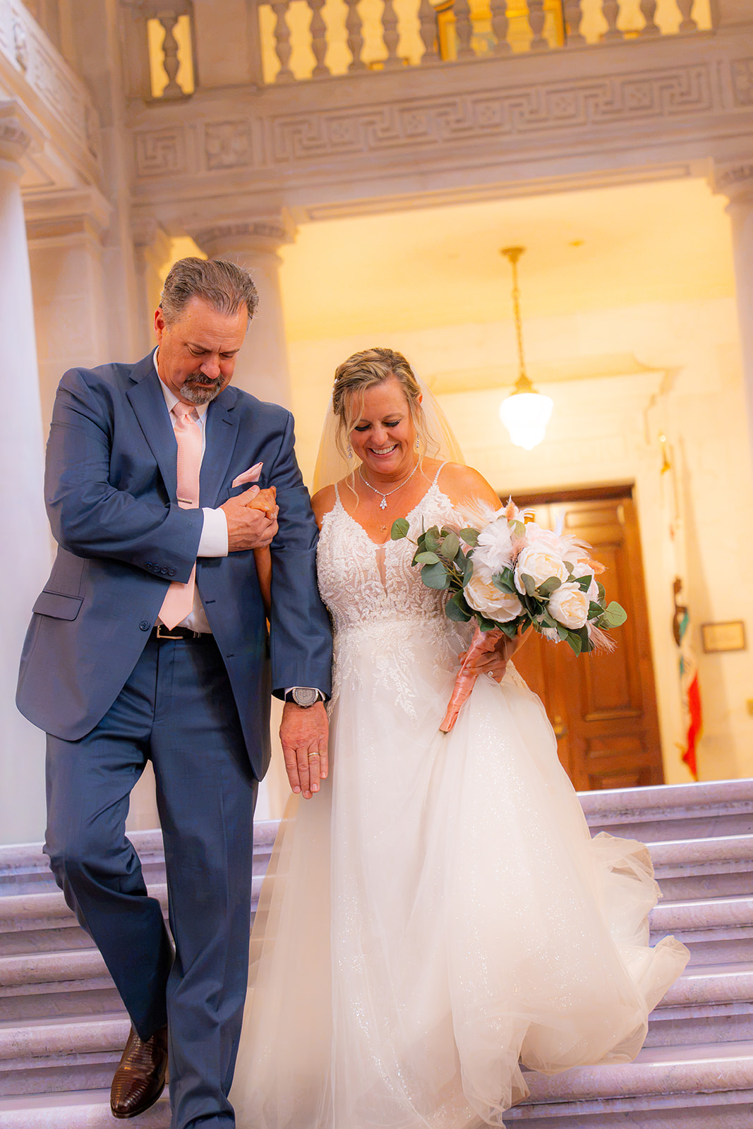Bride and her father smiling as they walk down the aisle during a San Francisco City Hall wedding