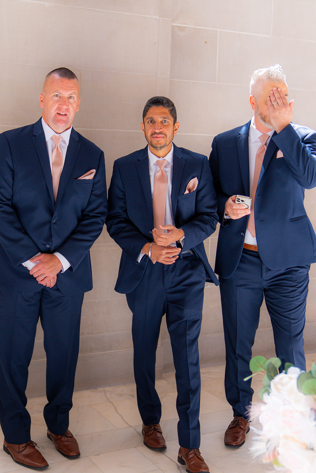 Emotional groomsmen reacting during a wedding ceremony at San Francisco City Hall