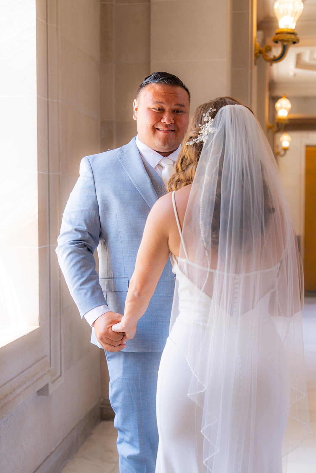 Couple sharing a first look during their wedding at San Francisco City Hall in California.