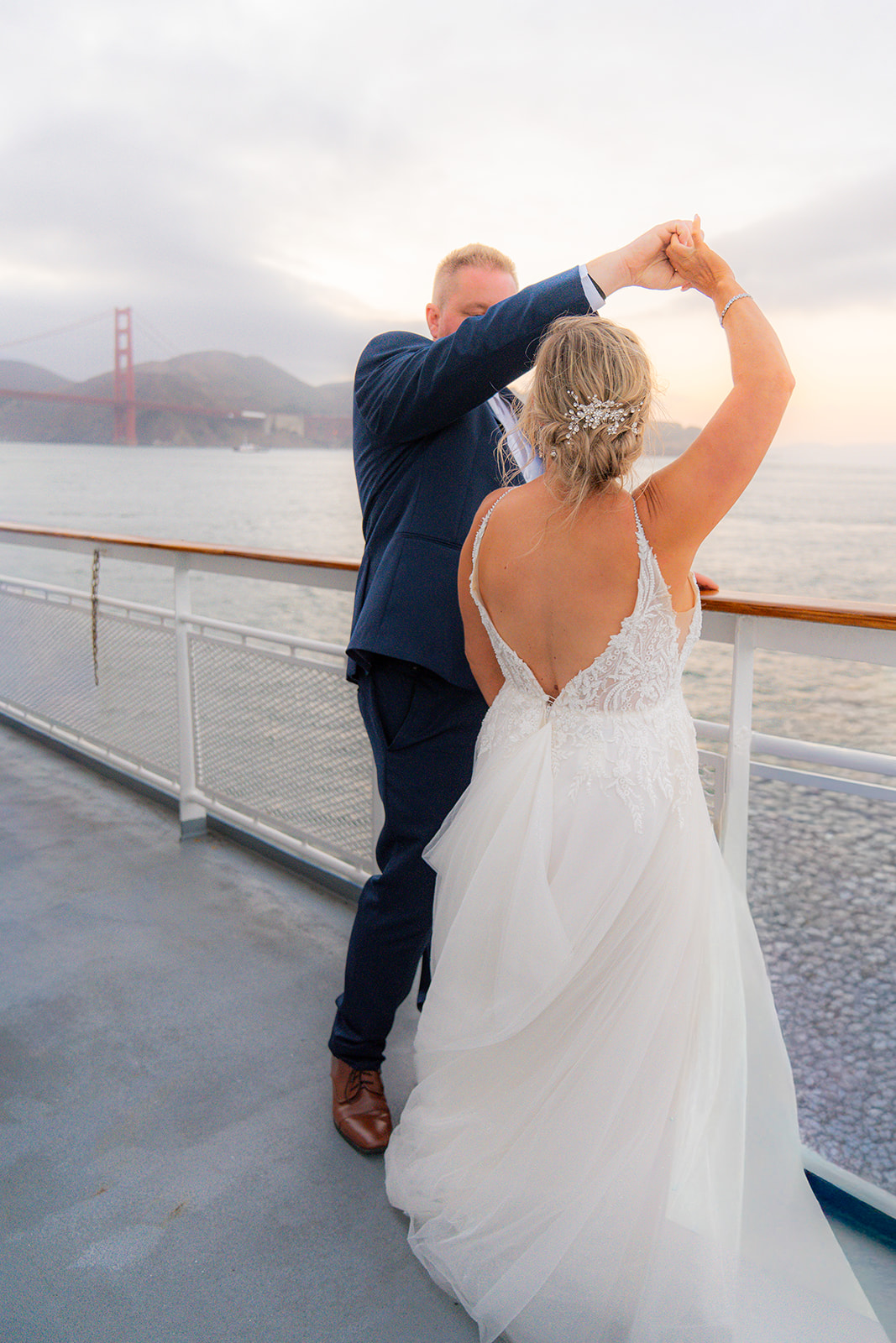 Bride and groom dancing together on the deck of a San Francisco wedding cruise