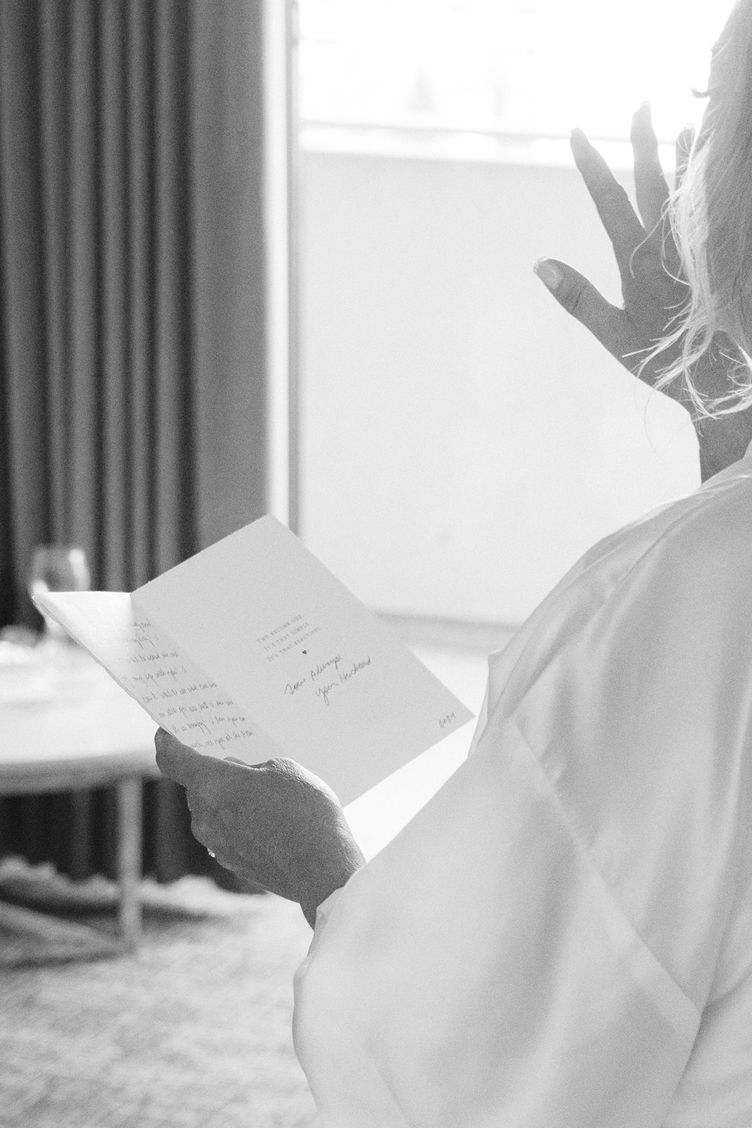 Emotional bride reading a letter from the groom before their San Francisco wedding ceremony