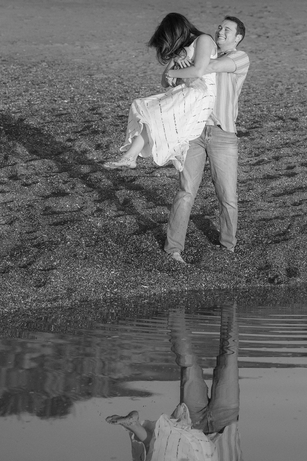 Couple playing barefoot together on the sand at a beach in Santa Cruz.