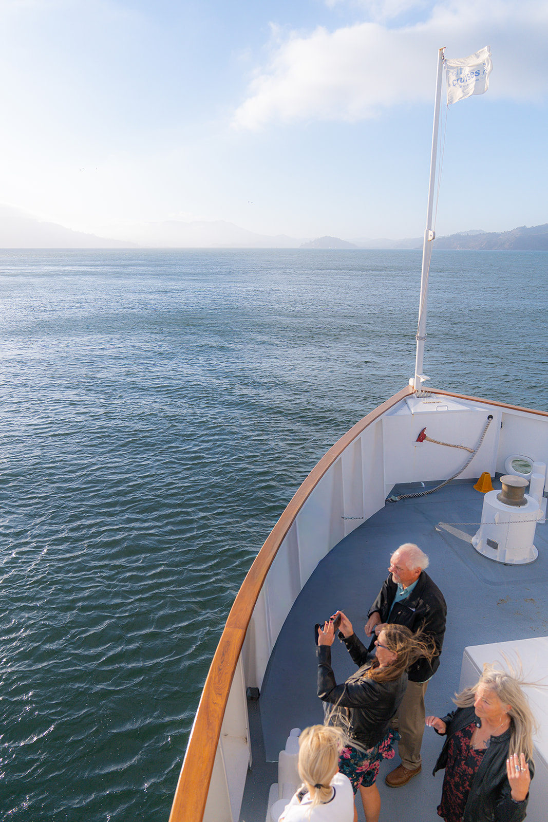 Wedding guests celebrating during a sunset cruise wedding reception on the San Francisco Bay