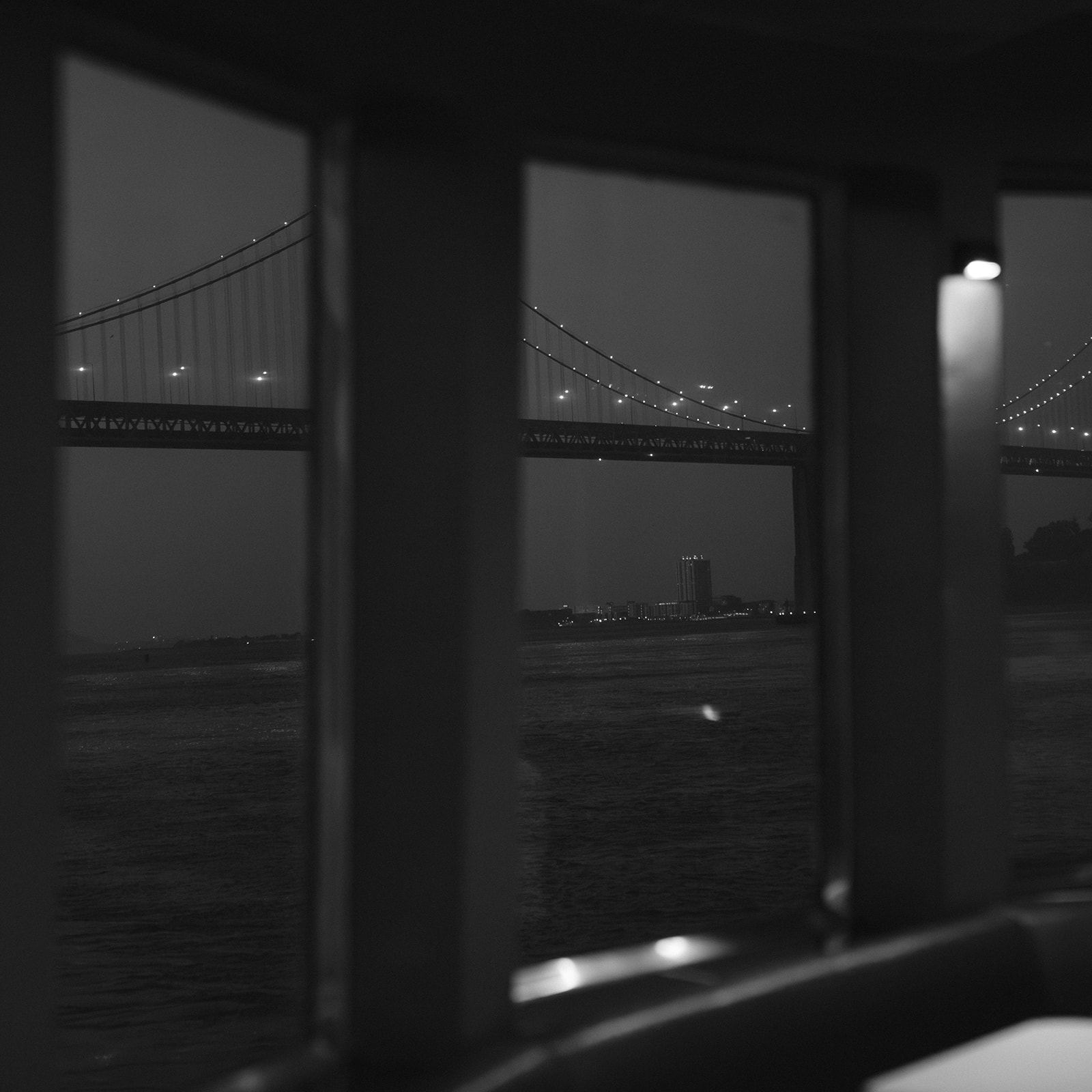 Evening view through a window during a wedding boat reception on the San Francisco Bay